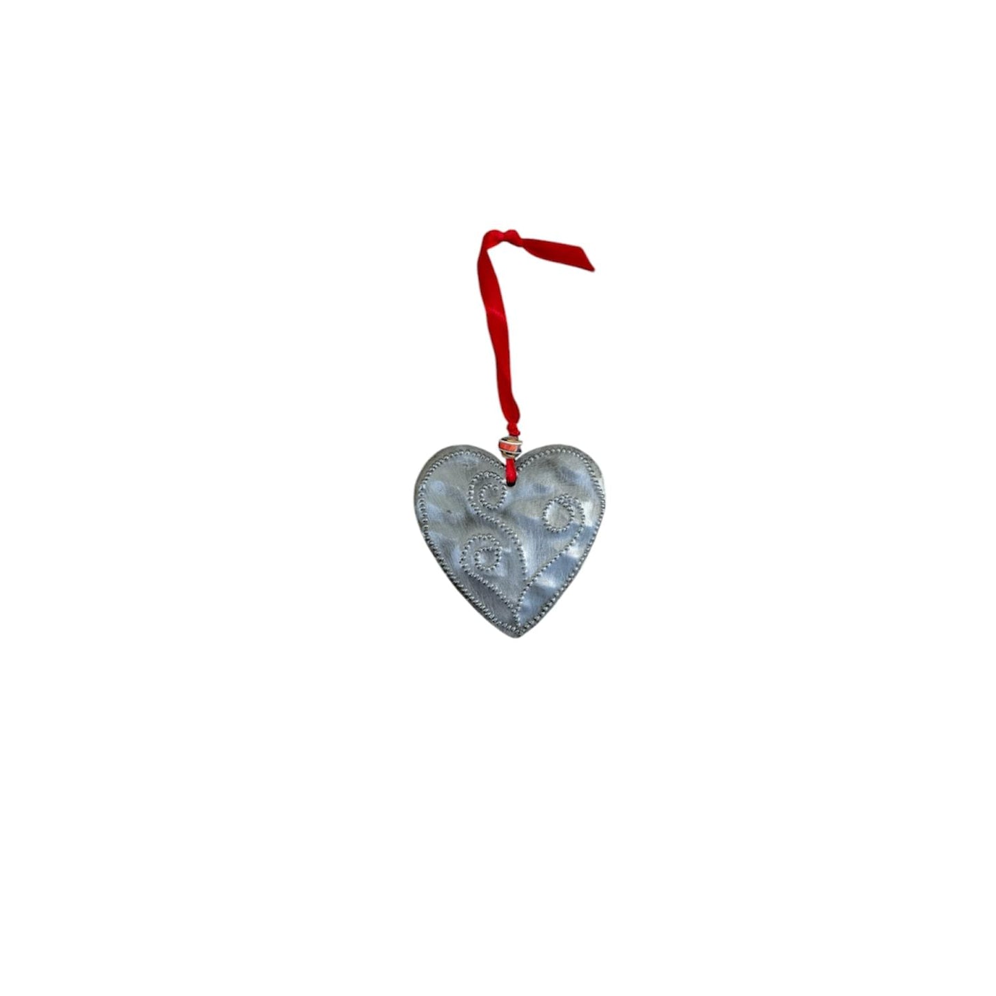 Handcrafted metal heart ornament with swirl design, red ribbon hanger, Haitian artisan decor
