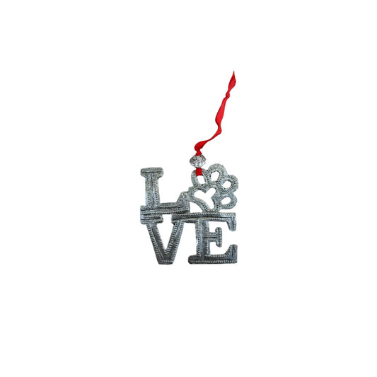 Handcrafted metal LOVE ornament with heart design, red ribbon, celebrating Haitian artisan artistry and culture