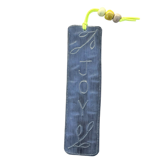Handmade Haitian affirmation bookmark placed inside an open book